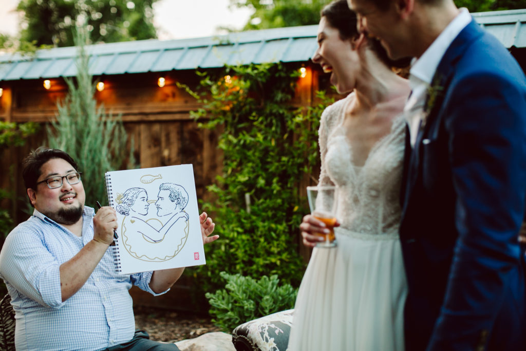 Jess and Stefan react to their drawing by laughing. Joy and laughter are common symptoms of Bad Drawings in Asheville.